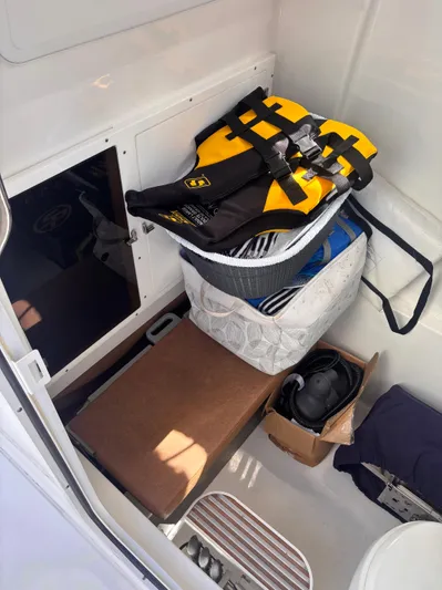  Yacht Photos Pics 2024 Sea Pro 322 DLX Offshore cabin with life jackets and storage items.