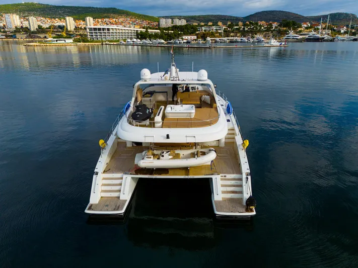 Clouds Yacht Photos Pics Luxury Sunreef 70 Power yacht, 2013 model, docked in a serene marina setting.
