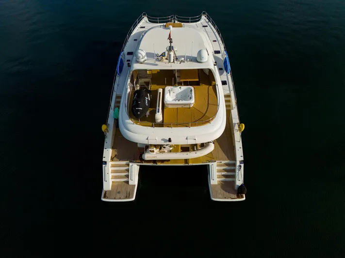 Clouds Yacht Photos Pics Aerial view of 2013 Sunreef 70 Power yacht on calm water.