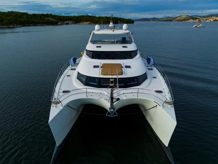 Clouds Yacht Photos Pics Front view of 2013 Sunreef 70 Power yacht on calm water.