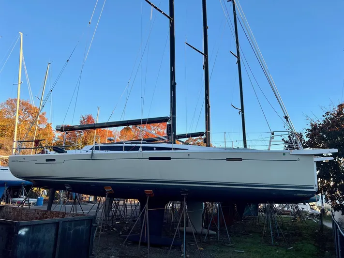 **4806tw Yacht Photos Pics 2017 Dehler 42c sailboat on stands, surrounded by autumn trees and clear blue sky.