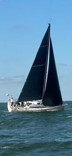 **4806tw Yacht Photos Pics 2017 Dehler 42c sailboat with black sails navigating on open water.