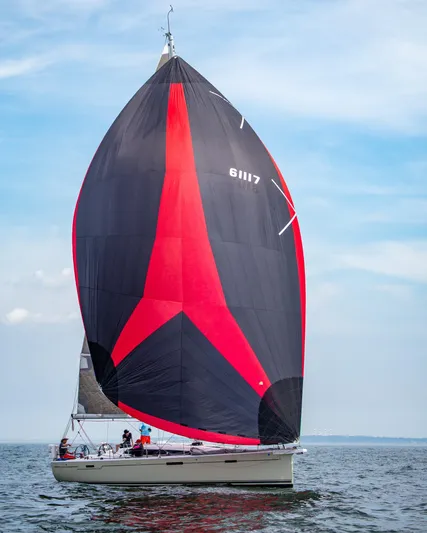**4806tw Yacht Photos Pics 2017 Dehler 42c sailboat with striking red and black spinnaker on open water.
