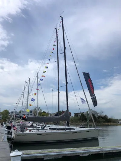 **4806tw Yacht Photos Pics 2017 Dehler 42c sailboat docked, adorned with colorful flags under a cloudy sky.
