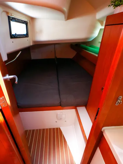**4806tw Yacht Photos Pics Cozy cabin interior of 2017 Dehler 42c sailboat with wooden finish and comfortable bedding.