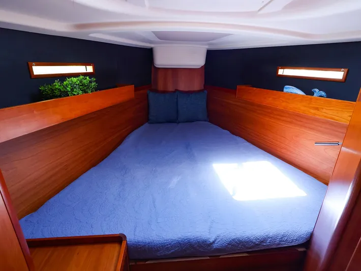 **4806tw Yacht Photos Pics Cozy cabin interior of 2017 Dehler 42c yacht with wooden finish and blue bedding.