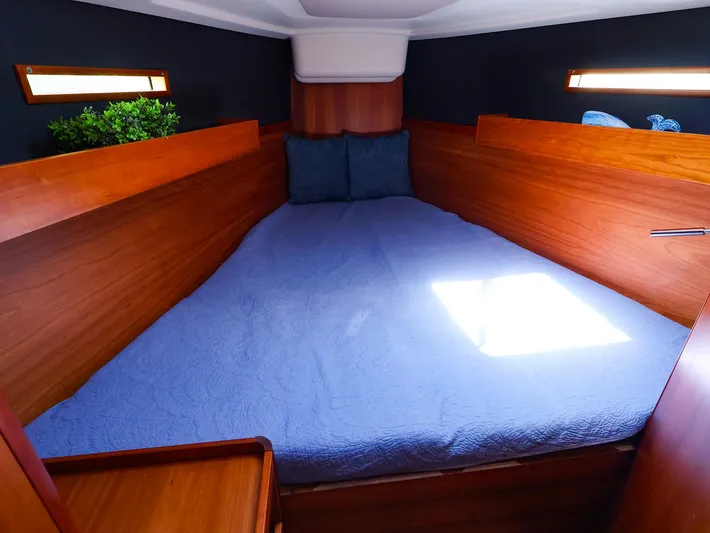 **4806tw Yacht Photos Pics Cozy cabin interior of 2017 Dehler 42c yacht with wooden finish and blue bedding.