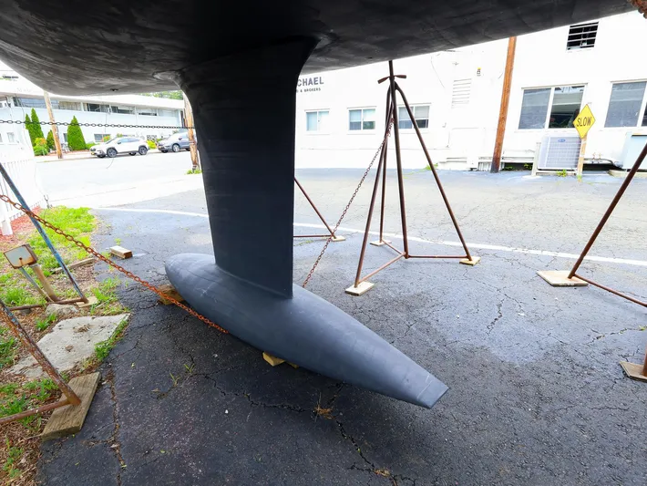 **4806tw Yacht Photos Pics Keel of 2017 Dehler 42c sailboat on stands in a parking lot.