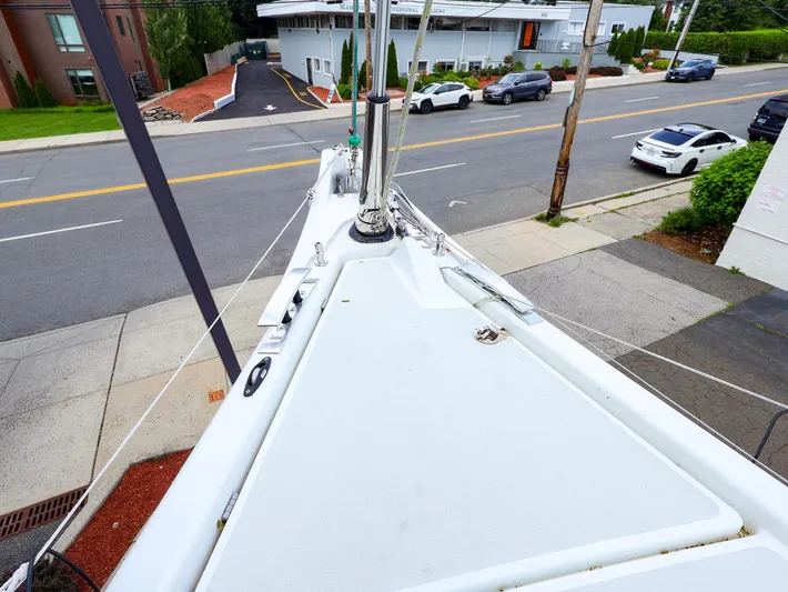 **4806tw Yacht Photos Pics Bow view of 2017 Dehler 42c yacht on urban street, showcasing deck and rigging.