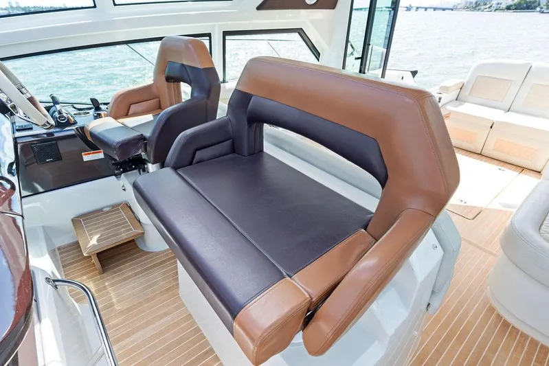 Two Segals Yacht Photos Pics Luxurious seating on 2019 Beneteau Gran Turismo 46 yacht with brown and black upholstery.