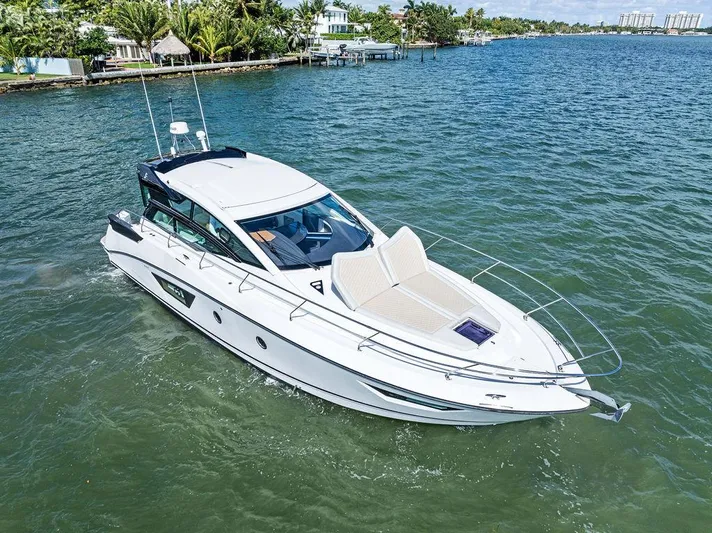 Two Segals Yacht Photos Pics 2019 Beneteau Gran Turismo 46 yacht cruising on a sunny day in a scenic waterway.