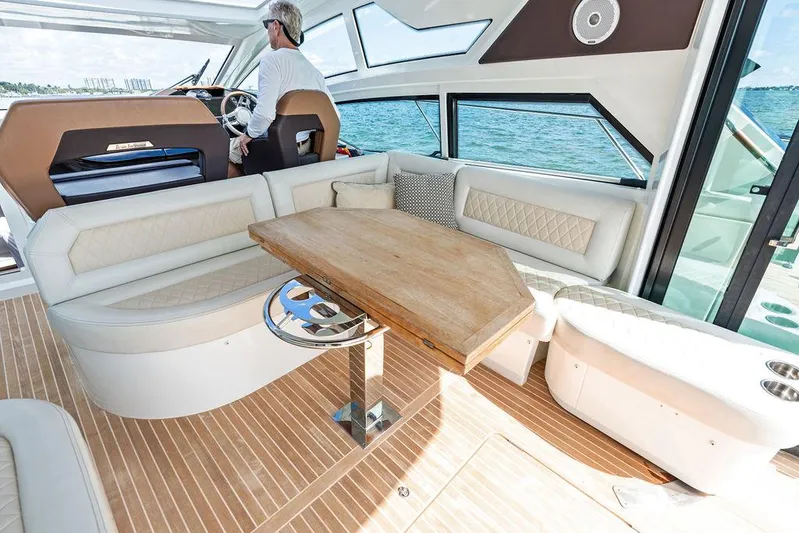 Two Segals Yacht Photos Pics Luxurious interior of 2019 Beneteau Gran Turismo 46 yacht with elegant seating and wooden table.