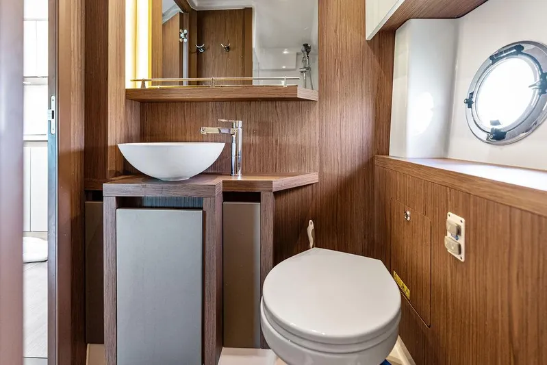 Two Segals Yacht Photos Pics Luxurious bathroom in 2019 Beneteau Gran Turismo 46 yacht with modern fixtures and wood finish.