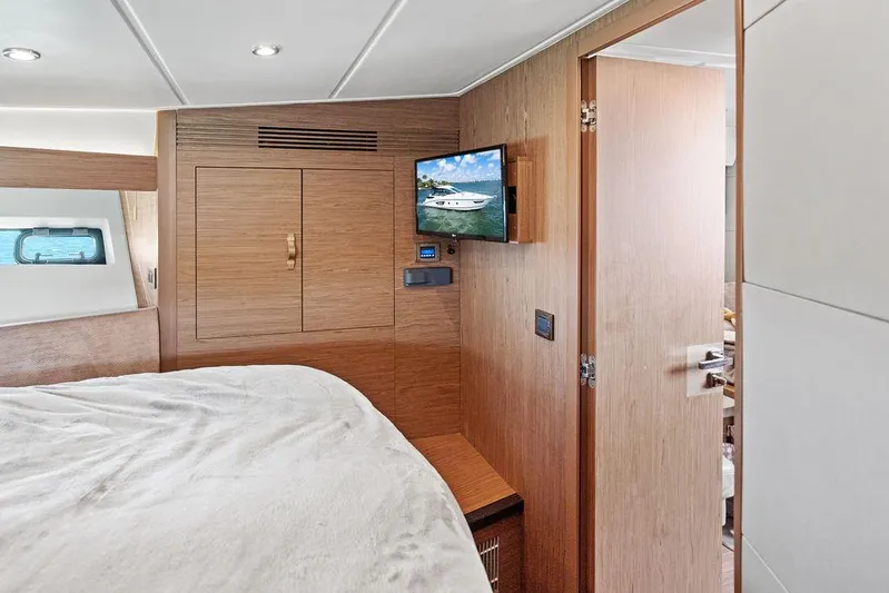 Two Segals Yacht Photos Pics 2019 Beneteau Gran Turismo 46 cabin interior with wood finish and mounted TV.