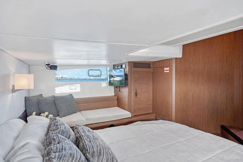 Two Segals Yacht Photos Pics Luxurious interior of 2019 Beneteau Gran Turismo 46 yacht, featuring cozy seating and elegant wood finishes.