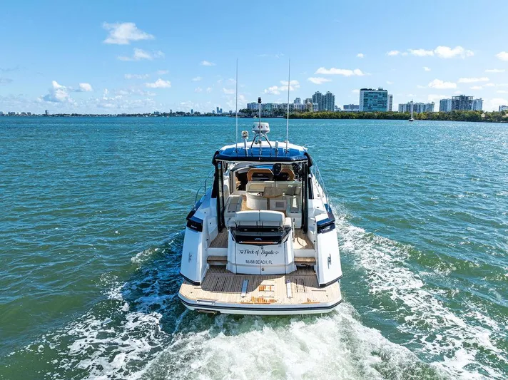 Two Segals Yacht Photos Pics 2019 Beneteau Gran Turismo 46 yacht cruising on a sunny day near city skyline.
