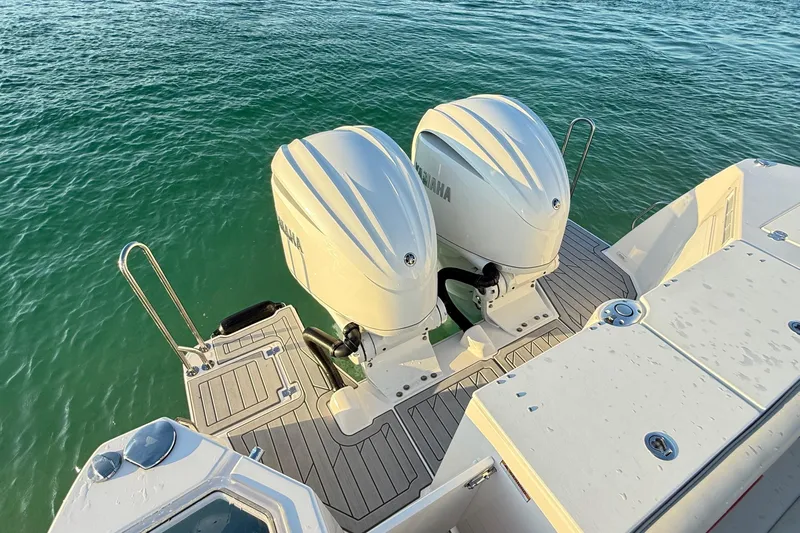  Yacht Photos Pics 2025 Solara S-310 CW boat with dual Yamaha outboard engines on water.