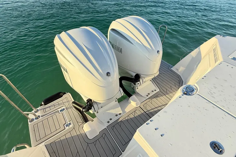  Yacht Photos Pics Twin Yamaha outboard engines on 2025 Solara S-310 CW boat, docked on calm water.