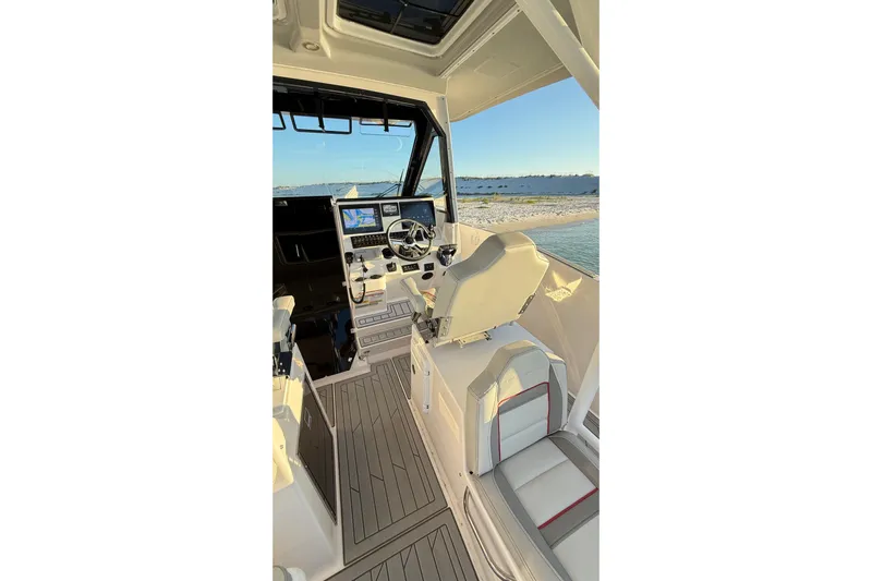  Yacht Photos Pics Interior view of 2025 Solara S-310 CW boat cockpit with modern controls and seating.