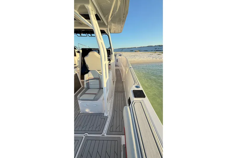  Yacht Photos Pics 2025 Solara S-310 CW boat docked on sandy beach, showcasing sleek deck design.