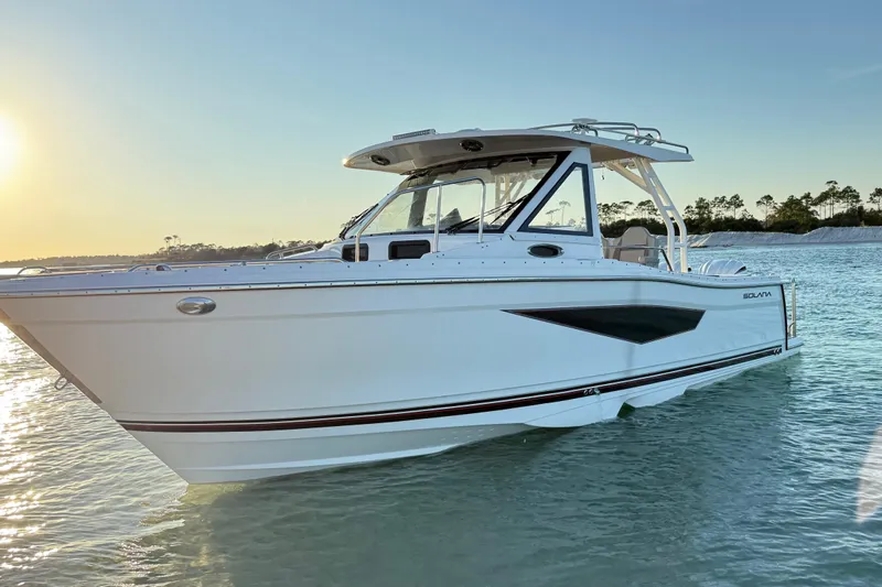  Yacht Photos Pics 2025 Solara S-310 CW boat on calm water at sunset.