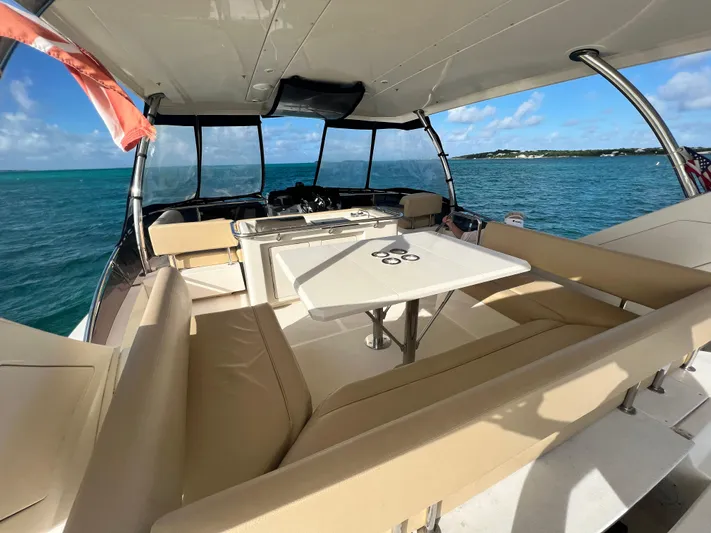 Gr8 Day Yacht Photos Pics Interior view of 2018 Aquila 44 Yacht with seating and table, overlooking ocean.