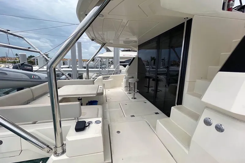 Gr8 Day Yacht Photos Pics 2018 Aquila 44 Yacht deck with seating and stairs, docked at marina.