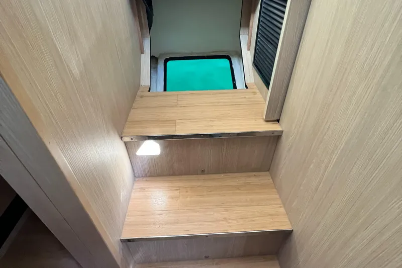 Gr8 Day Yacht Photos Pics Interior stairs of 2018 Aquila 44 Yacht with wooden finish and modern design.