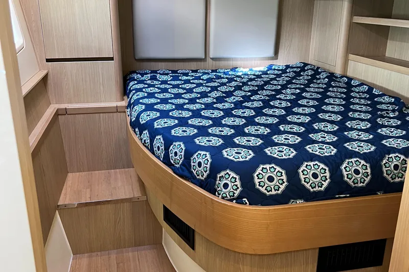 Gr8 Day Yacht Photos Pics Interior cabin of 2018 Aquila 44 Yacht with patterned bedspread.