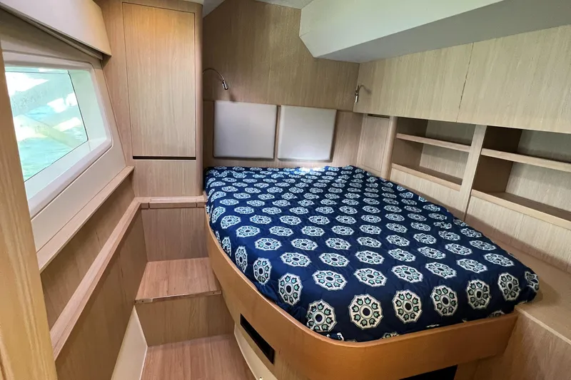Gr8 Day Yacht Photos Pics Cozy bedroom in 2018 Aquila 44 Yacht with patterned bedding and wooden cabinetry.