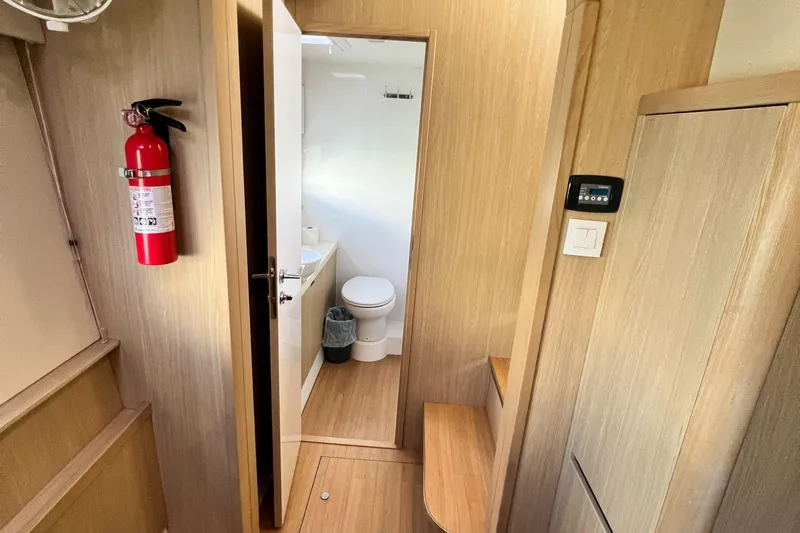 Gr8 Day Yacht Photos Pics 2018 Aquila 44 Yacht interior with bathroom, wooden finish, and fire extinguisher.