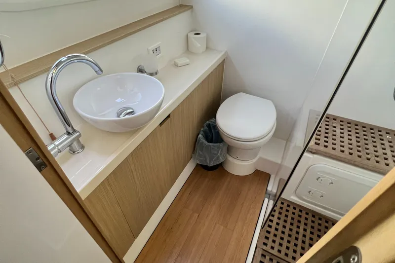 Gr8 Day Yacht Photos Pics Modern bathroom in 2018 Aquila 44 Yacht with sink, toilet, and wooden flooring.
