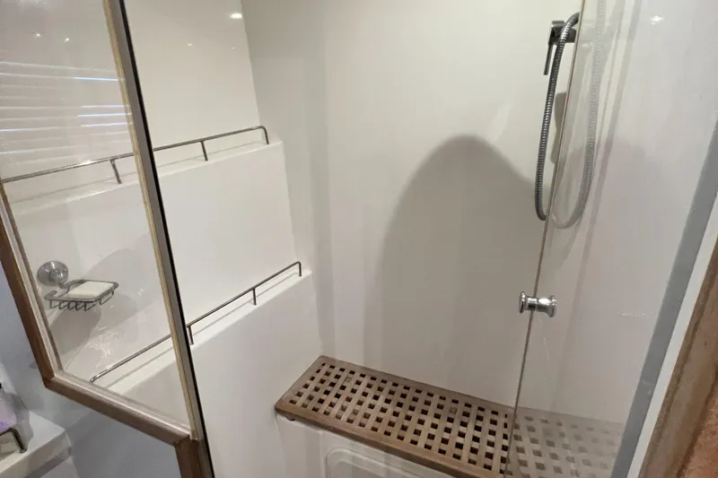 Gr8 Day Yacht Photos Pics Modern shower area in 2018 Aquila 44 Yacht with glass door and wooden bench.