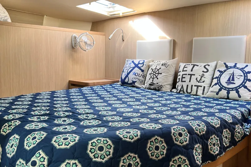 Gr8 Day Yacht Photos Pics Cozy bedroom in 2018 Aquila 44 Yacht with nautical-themed decor and patterned bedding.