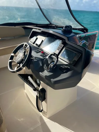Gr8 Day Yacht Photos Pics 2018 Aquila 44 Yacht helm with steering wheel and navigation controls.