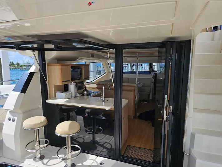 Gr8 Day Yacht Photos Pics Interior view of 2018 Aquila 44 Yacht with modern kitchen and seating area.