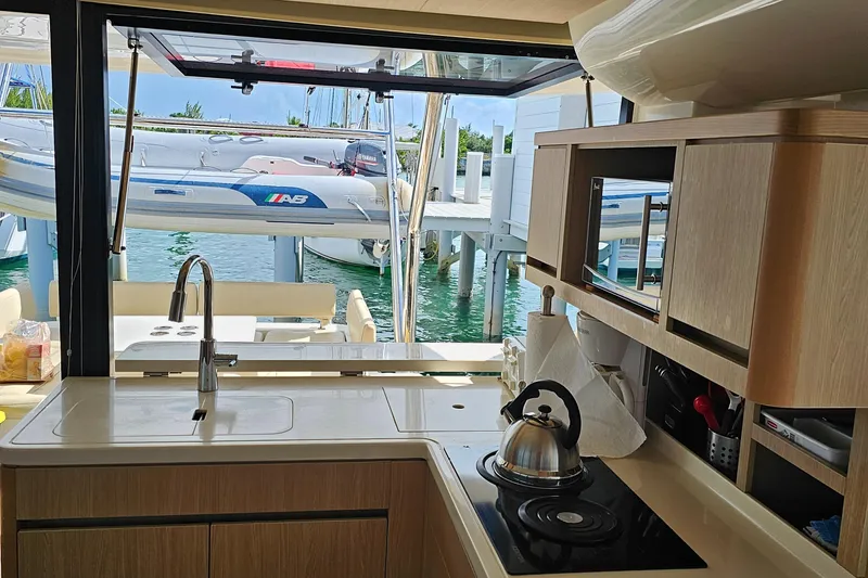 Gr8 Day Yacht Photos Pics Interior view of 2018 Aquila 44 Yacht kitchen with marina backdrop.