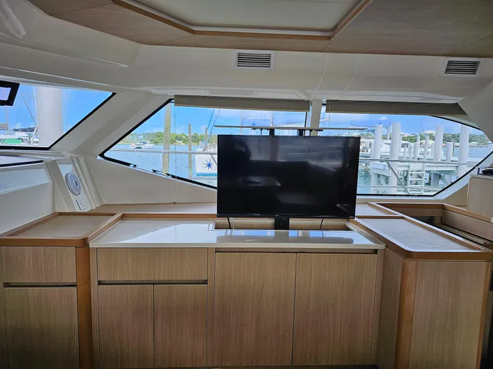 Gr8 Day Yacht Photos Pics Interior of 2018 Aquila 44 Yacht with TV and wooden cabinetry.