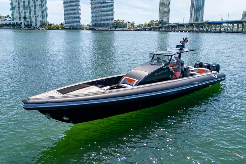 Fightertown Yacht Photos Pics 2019 Technohull OMEGA 45 boat on water, city skyline in background.