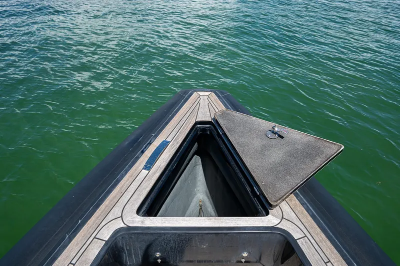 Fightertown Yacht Photos Pics Open storage compartment on 2019 Technohull OMEGA 45 boat, floating on green water.