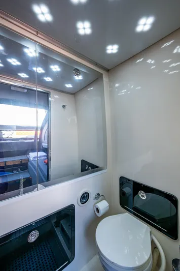 Fightertown Yacht Photos Pics Interior of 2019 Technohull OMEGA 45 bathroom with modern fixtures and mirror.