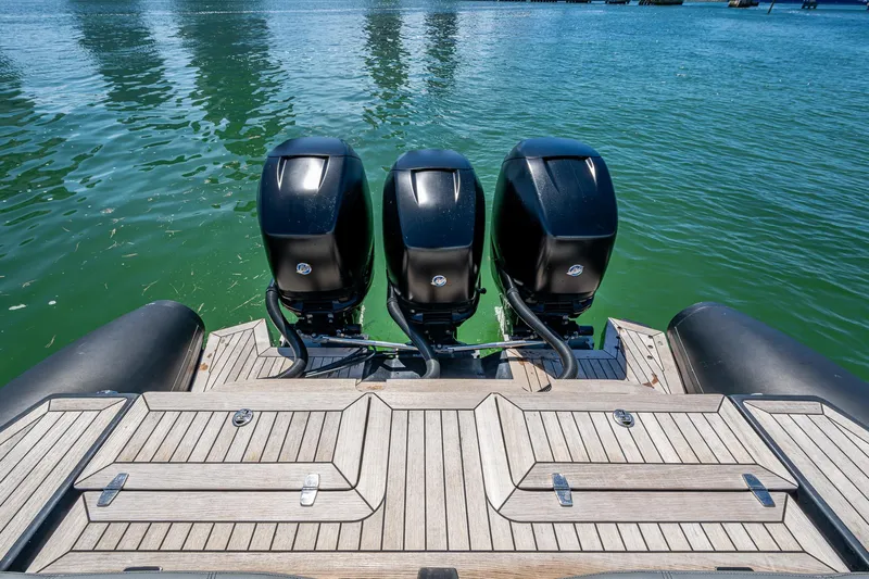 Fightertown Yacht Photos Pics Triple outboard engines on 2019 Technohull OMEGA 45, docked on calm water.