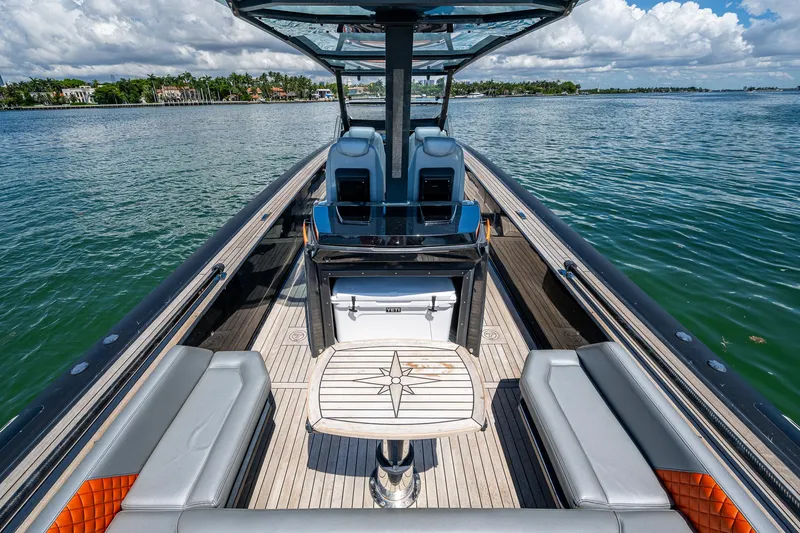 Fightertown Yacht Photos Pics 2019 Technohull OMEGA 45 boat interior with seating and table on calm water.