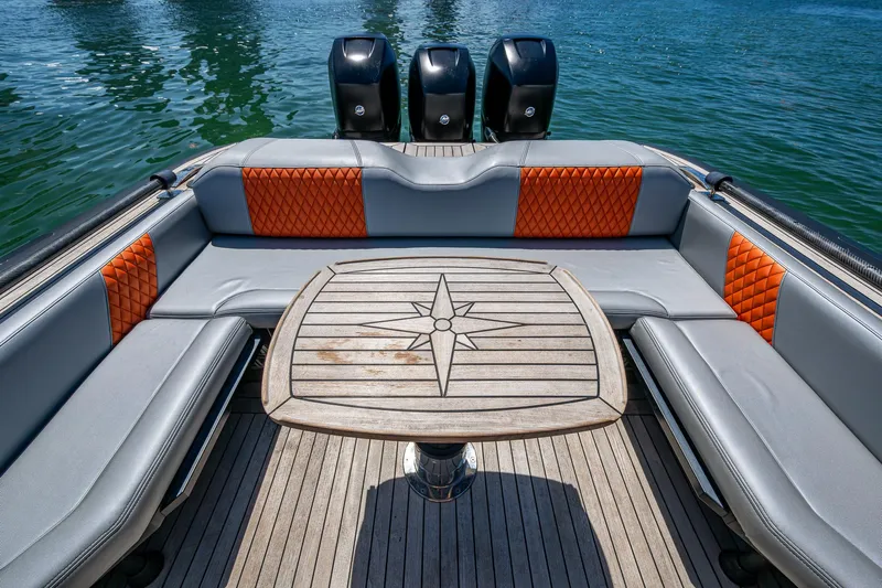 Fightertown Yacht Photos Pics Luxurious 2019 Technohull OMEGA 45 boat interior with stylish seating and wooden table.