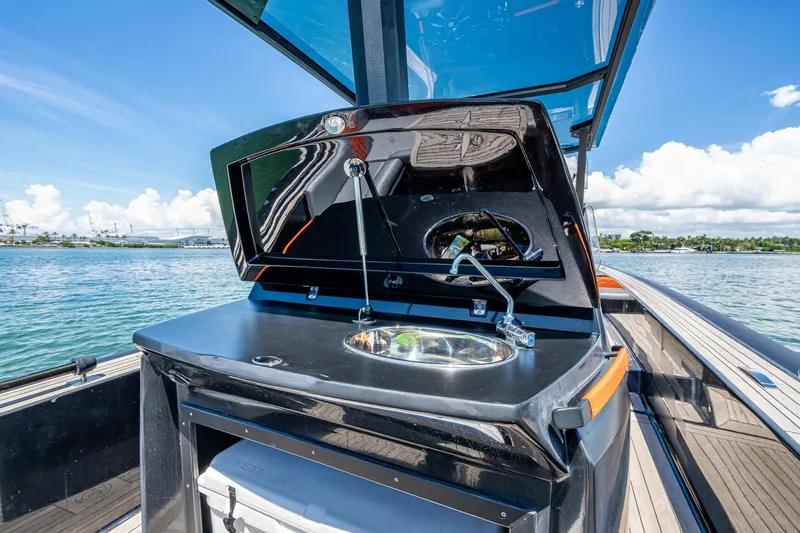 Fightertown Yacht Photos Pics 2019 Technohull OMEGA 45 boat with open sink and storage, docked on a sunny day.