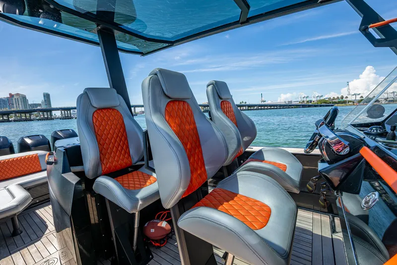 Fightertown Yacht Photos Pics Luxurious 2019 Technohull OMEGA 45 boat interior with stylish orange and gray seating.