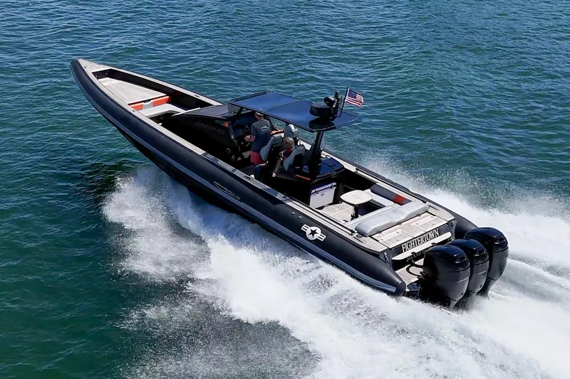 Fightertown Yacht Photos Pics 2019 Technohull OMEGA 45 speedboat cruising on open water with triple outboard engines.