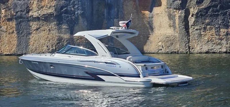 Yacht Photos Pics 2021 Formula 350 Crossover Bowrider boat on water near rocky cliffs.