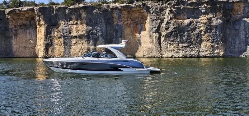  Yacht Photos Pics 2021 Formula 350 Crossover Bowrider cruising near rocky cliffs on a sunny day.