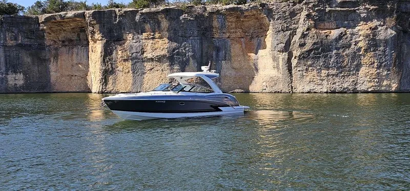  Yacht Photos Pics 2021 Formula 350 Crossover Bowrider cruising near rocky cliffs on a sunny day.